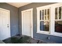 View of the screened front porch with gray walls, white trim, and a dark green floor at 1325 4Th Ne St, Winter Haven, FL 33881
