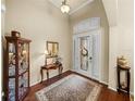 Traditional foyer with hardwood floors and a decorative rug leading to the glass front door at 1336 Oakmont Dr, Winter Haven, FL 33884