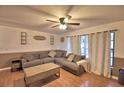 Comfortable living room featuring a large sectional sofa, coffee table, and bright windows at 1412 Covington Ct, Lake Wales, FL 33853