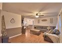 Open living room with a large couch, dining area, and plenty of space for entertaining at 1412 Covington Ct, Lake Wales, FL 33853