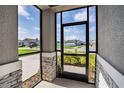 View from inside the screened porch, showcasing the neighborhood at 153 Summershore Dr, Auburndale, FL 33823