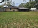Expansive backyard featuring a screened-in porch and a privacy fence, perfect for outdoor living at 2016 Amesbury Dr, Auburndale, FL 33823