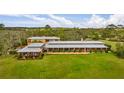 An aerial view of the home and surrounding lush green acreage at 2300 N Scenic Hwy # 120, Lake Wales, FL 33898