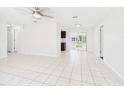 Bright and airy living room with tile flooring, recessed lighting, and sliding glass doors at 2434 Mill Run Blvd, Kissimmee, FL 34744