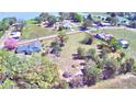Aerial view of the property showcasing its location and surrounding landscape near a lake at 3065 E Central Ave, Bartow, FL 33830