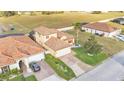 Well-maintained property features lush landscaping, tile roof, and a paved driveway at 369 Villa Sorrento Cir, Haines City, FL 33844