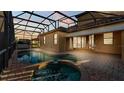 Relaxing outdoor living space features a screened pool with a connected hot tub at 369 Villa Sorrento Cir, Haines City, FL 33844