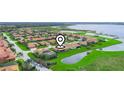 Aerial view of a residential community featuring well-maintained landscaping and a pond at 4073 Sable Loop Dr, Lake Wales, FL 33859