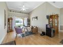 Bright living room featuring hardwood floors, neutral walls, a ceiling fan, and sliding glass doors at 415 Ruby Lake Pl, Winter Haven, FL 33884