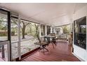 Relaxing screened porch featuring outdoor seating with a table, great for enjoying the outdoors at 428 Garrett Ridge Ct, Winter Haven, FL 33880