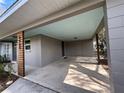 Spacious covered carport features wooden support beams, blue painted ceiling, and access to side entry at 4909 Fleetwood St, Lake Wales, FL 33859