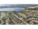 Beautiful aerial view of a residential neighborhood near a large lake, showcasing the community's layout and natural surroundings at 629 Copeland Dr, Haines City, FL 33844
