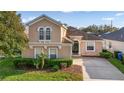 Inviting home exterior with lush landscaping, a manicured lawn, and a welcoming entrance with decorative trim at 629 Copeland Dr, Haines City, FL 33844