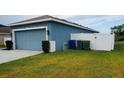 Blue single Gathering home with well kept lawn and a two car garage at 663 Lucerne Blvd, Winter Haven, FL 33881