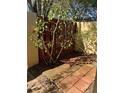 Brick-paved patio area enclosed by a red fence and a green leafy tree at 683 Broadmoor Cir # 683, Winter Haven, FL 33884