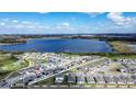 Community aerial view showcasing a large lake, residential homes, and a neighborhood layout at 708 Simone Ct, Haines City, FL 33844