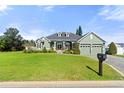 Well-maintained home boasting lush landscaping, a brick driveway, two-car garage, and charming curb appeal at 819 Hart Lake St, Winter Haven, FL 33884