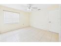 Bedroom featuring neutral walls, tiled floor, a window with blinds, and a closet at 91 W Cedarwood Cir, Kissimmee, FL 34743
