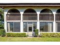 Condo patio with a privacy screen, arched windows, and a well-maintained lawn at 1104 Country Club Dr # A-4, Lake Wales, FL 33898