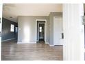 Bright living room featuring gray walls, light-colored laminate flooring, and plenty of natural light at 1328 3Rd Ne St, Winter Haven, FL 33881