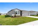Beautifully landscaped single-Gathering home with a well-maintained lawn and inviting entrance at 1340 Oak Valley Drive, Auburndale, FL 33823
