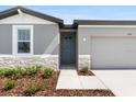 Charming single-Gathering home featuring an inviting entrance and an attached garage at 1340 Oak Valley Drive, Auburndale, FL 33823