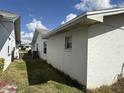 Exterior side view of home with air conditioning unit and a fenced backyard at 1411 Grand Cayman Cir, Winter Haven, FL 33884