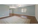 Spacious living room with hardwood floors and a neutral area rug bathed in natural light from a large window at 1447 Kingfish Ln, Winter Haven, FL 33884