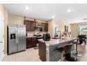 Bright eat-in kitchen featuring dark wood cabinets, stainless steel appliances, and granite countertops at 148 Emanuelle Dr, Winter Haven, FL 33884