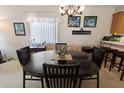 Charming dining room with a round wooden table, seating for six, and sunny window at 1822 Nicaragua Way, Winter Haven, FL 33881