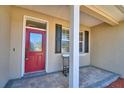 A welcoming red front door with decorative glass and a covered porch at 2110 Saddlewood Dr, Bartow, FL 33830