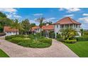 Gorgeous home with red tile roof, manicured landscaping, circular driveway, and a three-tiered fountain at 2300 N Scenic Hwy # 61, Lake Wales, FL 33898