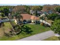 A high angle aerial view shows the lawn, garden and general setting of the property at 315 Bayberry Dr, Polk City, FL 33868