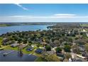 This aerial photo features a view of a community with a lake at 315 Bayberry Dr, Polk City, FL 33868