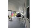 Spacious carport with room for multiple vehicles and outdoor seating area at 32 Berna Cir, Winter Haven, FL 33884