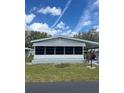 Cozy single-story home featuring a screened-in porch and well-maintained lawn at 32 Berna Cir, Winter Haven, FL 33884