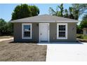 Charming home featuring a new concrete driveway, modern paint, and meticulously maintained landscaping at 3438 Avenue E Nw, Winter Haven, FL 33880
