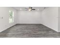 Bright living room featuring modern flooring, recessed lighting, and abundant natural light at 3438 Avenue E Nw, Winter Haven, FL 33880