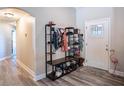 Stylish entryway features modern storage solutions and elegant wood-look flooring, perfect for organization at 3467 Sutton Ridge St, Lakeland, FL 33810
