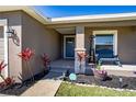 Inviting front porch with cozy seating area and landscaped garden, enhancing curb appeal at 3467 Sutton Ridge St, Lakeland, FL 33810