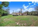 Exterior view of the property surrounded by a spacious, well-maintained lawn at 352 W Graham Park Dr, Haines City, FL 33844