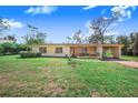 Inviting one-story home featuring well-manicured front yard and covered carport area at 352 W Graham Park Dr, Haines City, FL 33844