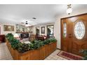 Inviting foyer with a decorative wood accent wall, tiled floors, and a charming leaded glass door at 3614 Twisted Oak Ct, Lake Wales, FL 33898