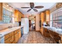 Spacious kitchen with a view into the dining room, wooden cabinets, and tile flooring at 3655 N Scenic Hwy, Lake Wales, FL 33898