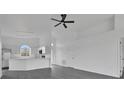 Bright open-concept living area with updated flooring and view to the modern kitchen at 412 Savanna Pointe St, Winter Haven, FL 33884