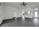 Spacious living room features modern gray floors, lots of light, and open layout at 412 Savanna Pointe St, Winter Haven, FL 33884