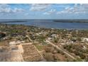 Aerial view of a home in a residential area near a lake, surrounded by lush greenery and other houses at 42 Mountain Dr, Babson Park, FL 33827