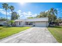 Charming single-story home with an attached garage and a sunny front yard at 5115 Woodgreen Ln, Lakeland, FL 33811