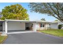 Exterior view of the home showing the carport and tidy front lawn at 513 Kelsey St # 513, Lakeland, FL 33803
