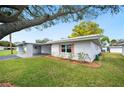 Charming single-story home with lush green lawn and attached carport at 513 Kelsey St # 513, Lakeland, FL 33803